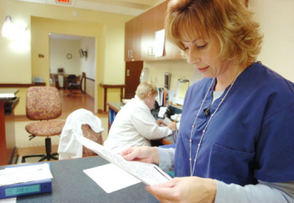 Doctor reading clipboard